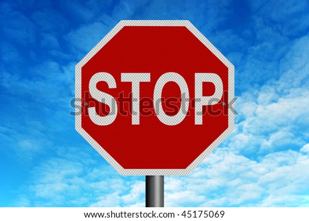A red and white reflective \'Stop\' sign in front of a bright blue summer sky