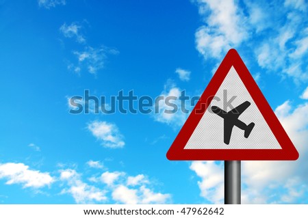 Photo realistic metallic reflective \'low flying aircraft\' / \'sudden aircraft noise\' road sign, against a bright blue sky. With space for your text / editorial overlay.