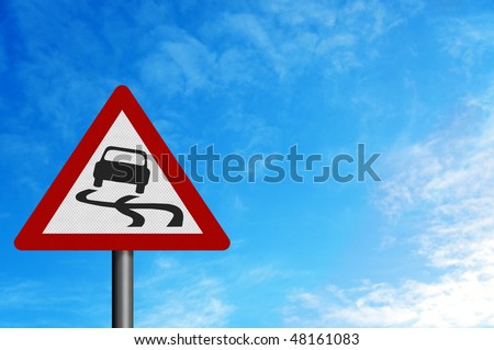 Photo realistic reflective metallic \'slippery road\' sign, against a bright blue sky.