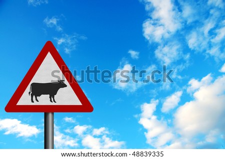 Photo realistic metallic reflective \'cattle\' sign, against a bright blue sky. With space for your text overlay / editorial