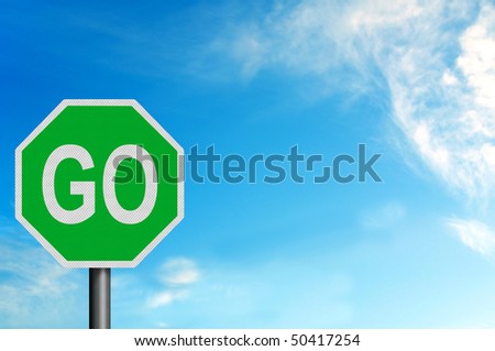 Photo realistic metallic reflective \'Go\' sign, against a bright blue sunny summer sky. With space for your text / editorial overlay