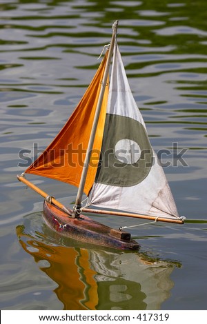 Wooden sailing boats in jardin des tuileries paris france, Children can hire a small wooden toy sailing boat and using a stick push it around the pond