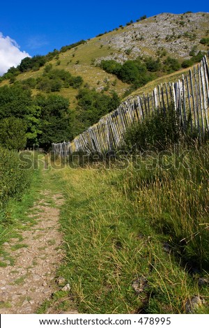 Walking path lined by picket fence in the English peak district