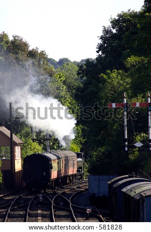 Steam train pulling carriages away from station, severn valley railway, bewdley, uk