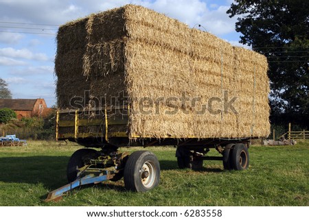 straw hay bales on a trailer in a field meriden solihull west midlands england uk