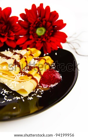 fresh pancakes with raspberry jam, coconut and chocolate