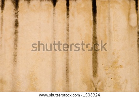 Grunge streaks down the side of a city building.