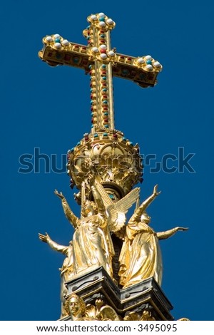 Ornate cross on top of the Albert Memorial, London, England.