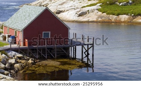 A charming red fishing hut on the Atlantic coastline of Nova Scotia, Canada.