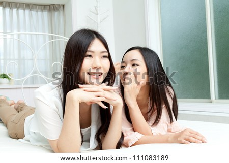 Beautiful young women relaxing in bedroom