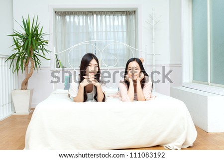Beautiful young women relaxing in bedroom