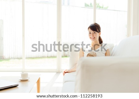 Beautiful young woman relaxing in the room. Portrait of asian.