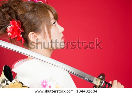 Beautiful japanese kimono woman with japanese sword
