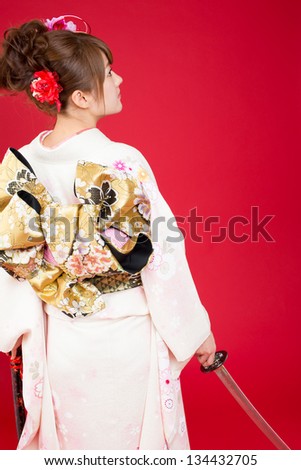 Beautiful japanese kimono woman with japanese sword