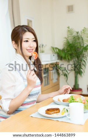 Beautiful asian woman eating lunch