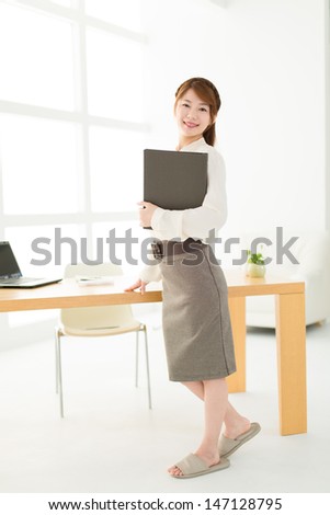 Beautiful young businesswoman working in office