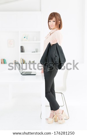 Beautiful young businesswoman working in office