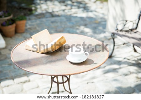 Vintage books and coffee cup on table