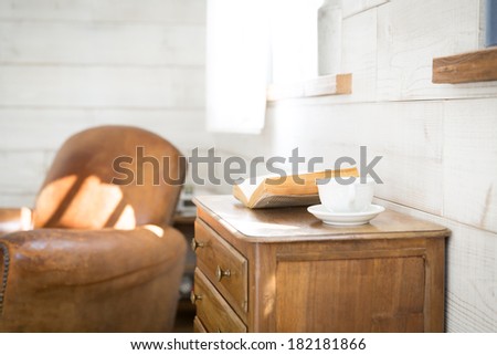 Vintage books and coffee cup on furniture