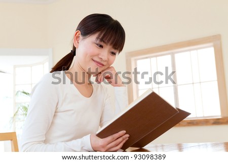 Beautiful asian woman reading a book