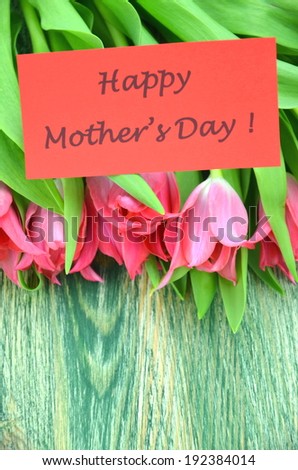 happy mothers day and bouquet of gorgeous red tulips
