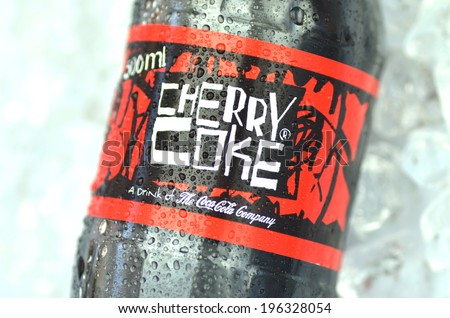 KWIDZYN, POLAND -Â?Â? MAY 26, 2014: Bottle of Cherry Coke drink on ice cubes. Cherry Coke is cherry-flavored kind of Coca-Cola produced by Coca-Cola Company. Cherry Coke was introduced in 1985