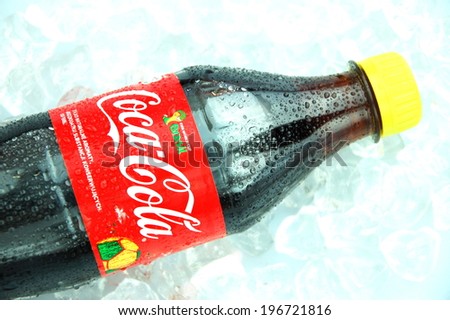 KWIDZYN, POLAND - MAY 26, 2014: Bottle of Coca-Cola drink on ice cubes. Coca-Cola is carbonated soft drink produced by Coca-Cola Company. Coca-Cola was introduced in 1886