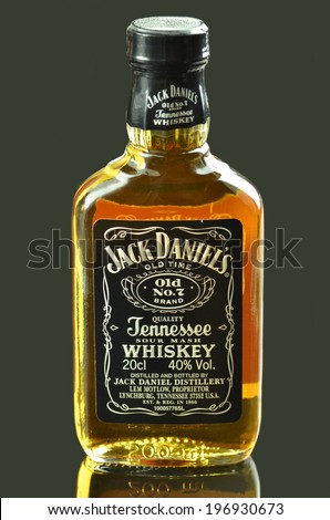KWIDZYN, POLAND - MAY 29, 2014: Small bottle of Jack Daniels whiskey isolated on dark background.  Jack Daniels sour mash whiskey has been distilled in Tennessee USA since 1866