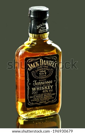 KWIDZYN, POLAND - MAY 29, 2014: Small bottle of Jack Daniels whiskey isolated on dark background.  Jack Daniels sour mash whiskey has been distilled in Tennessee USA since 1866