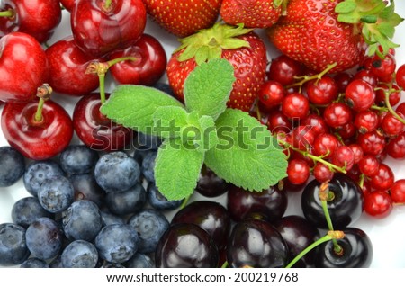 variety of soft fruits, strawberries, raspberries, cherries, blueberries, currants isolated on white