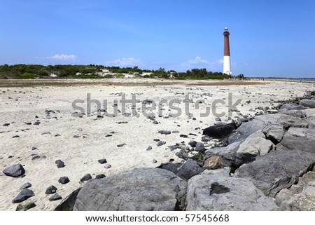 Barnegat Lighthouse seen from the New Jersey Shore.. Constructed in 1857, operational from 1958 to 1927. Barnegat Lighthouse is located in the town of  Barnegat Light, New Jersey