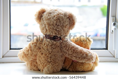 Two teddy bears holding in one\'s arms
