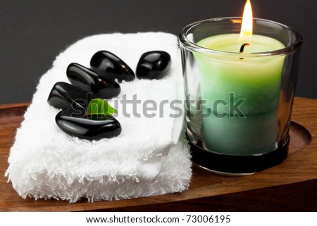 White towels with spa black stones and candle