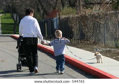 grandma and grandson walking the dog