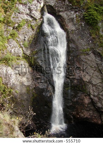 Plain waterfall falling on rocks