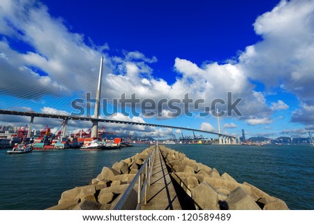 Port warehouse with containers and industrial cargoes , view under bridge on water break at day