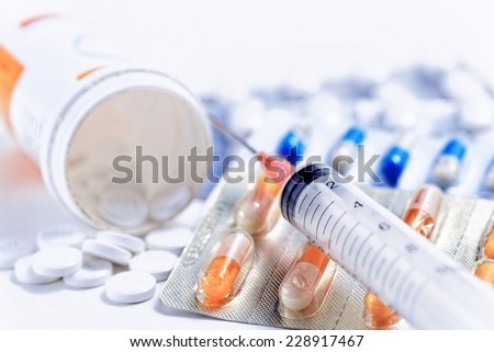 Syringe with glass vials and medications pills drug