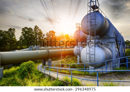 Glow light of petrochemical industry water tank on sunset.