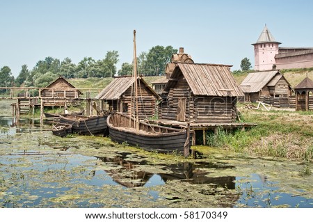 Authentic old Russian village landscape with water mill and wooden bridge