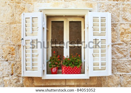 Old Shutter windows with a flowers. Montenegro. Mediterranean