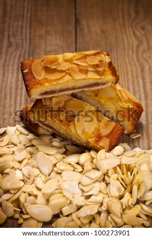 Delicious almond sponge slices on a wooden table. Almond cake.