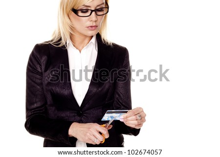 Woman cutting credit card. A blond businesswoman cutting up an expired credit card on a white background.