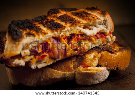 Toasted  sandwich. Toasted cheese, tomato and onion sandwich done on the BBQ.