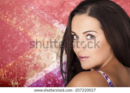 A beautiful woman over a colourful South African flag background looking over her left shoulder.