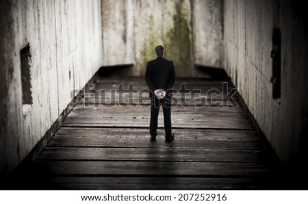 Abstract concept image of a businessman feeling trapped in the hard world of business.