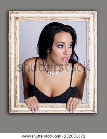 Woman trapped in frame. Abstract image of a surprised woman trapped in a picture frame.