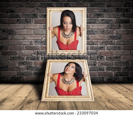 Abstract image of a beautiful woman trapped in two picture frames and herself looking .