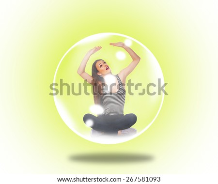 Woman trapped inside a soap bubble over yellow background.