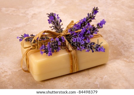 A bar of handmade lavender soap decorated with fresh lavender. Lavender soap.