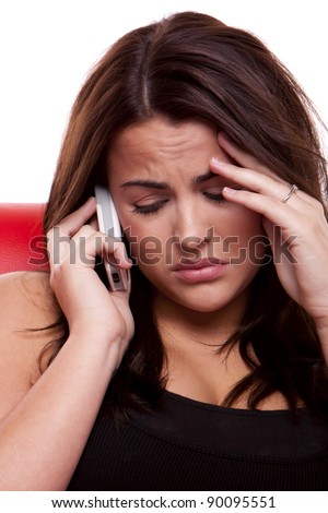 A young woman is feeling sad as she is talking on here mobile cell phone. - stock-photo-a-young-woman-is-feeling-sad-as-she-is-talking-on-here-mobile-cell-phone-a-young-woman-being-sad-90095551